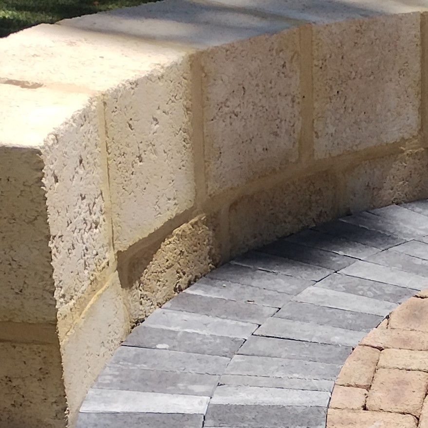Mixed colour paving for circle firepit area with limsetone seating.